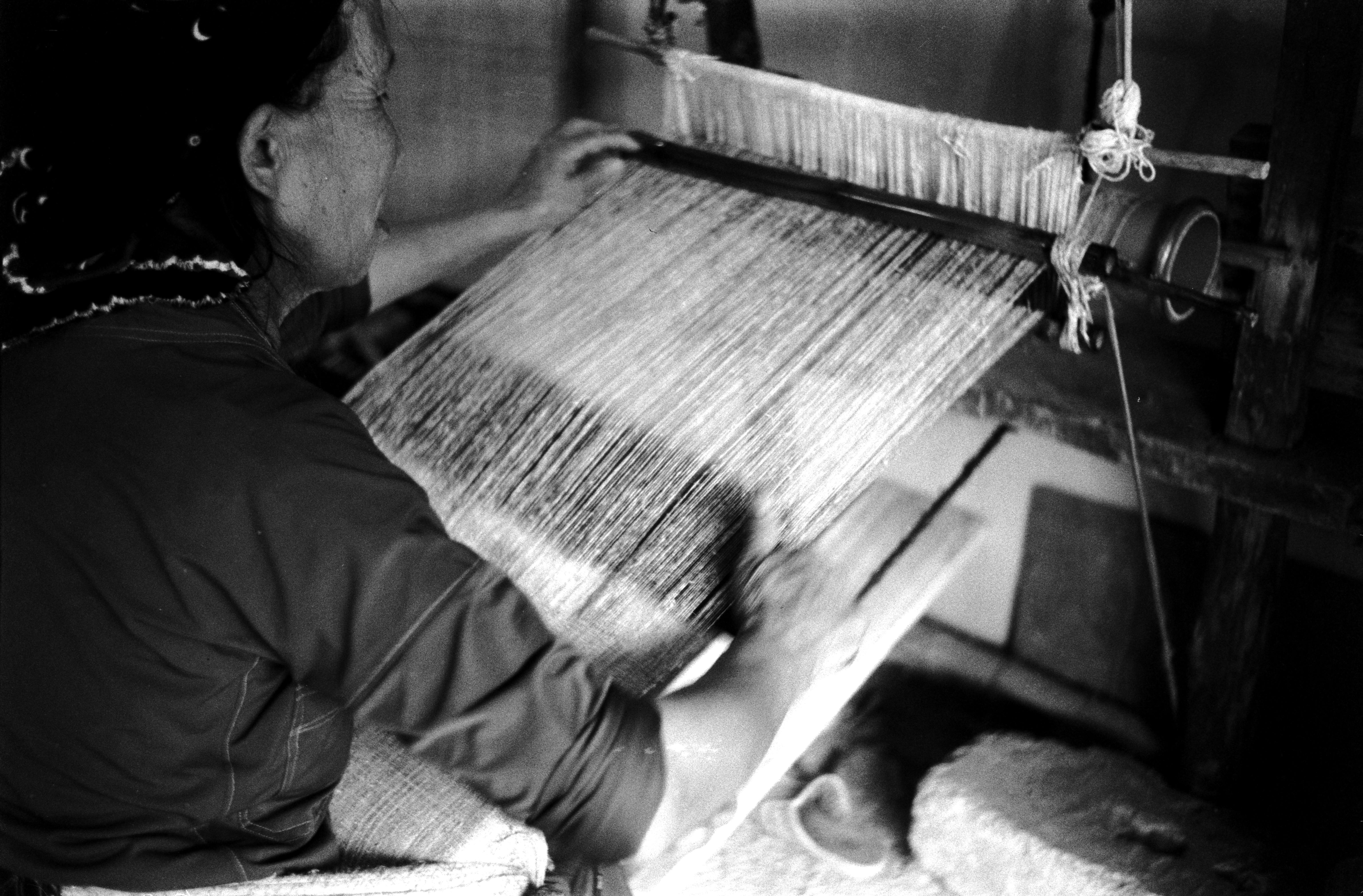 Traditional heritage weaver crafting authentic handmade textiles on wooden loom